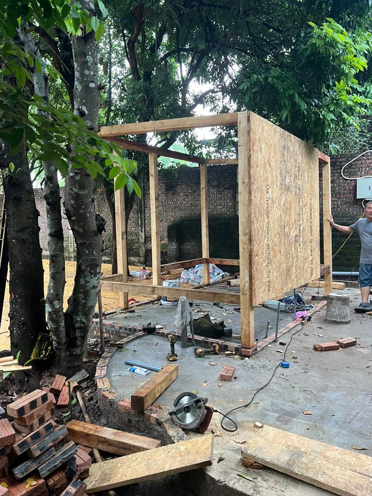 Corner view of the Garden Laboratory's timber and OSB frame taking shape among the trees